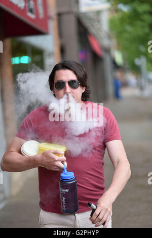 Ann Arbor, MI, USA. 1st June, 2016. A man uses a vaporizer on Liberty Street in downtown Ann Arbor, MI on June 1, 2016. © Mark Bialek/ZUMA Wire/Alamy Live News Stock Photo