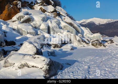 Huge icicles on rocks. Stock Photo