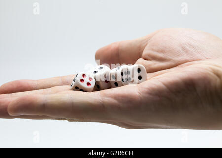 Human hand ready to roll the dice on white isolated background - Try luck, Take Risk or Business concept (Focus on dices) Stock Photo