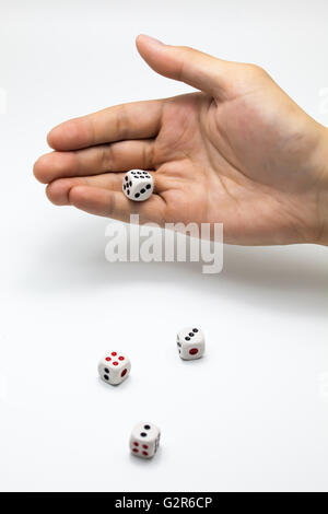 Human hand ready to roll the dice on white isolated background - Try luck, Take Risk or Business concept (Focus on hands) Stock Photo