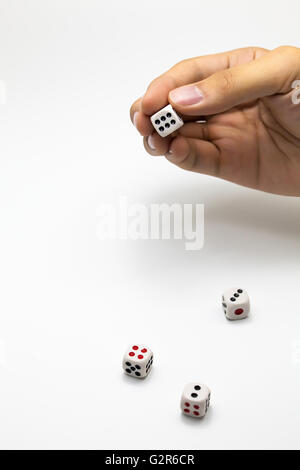 Human hand ready to roll the dice on white isolated background - Try luck, Take Risk or Business concept (Focus on hands) Stock Photo