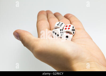 Human hand ready to roll the dice on white isolated background - Try luck, Take Risk or Business concept (Focus on dices) Stock Photo