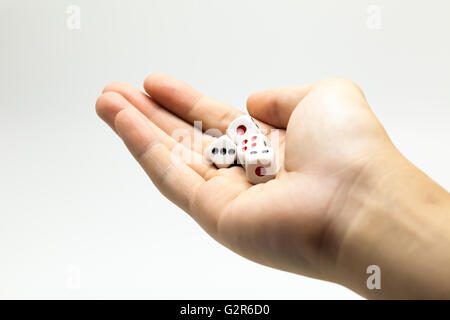 Human hand ready to roll the dice on white isolated background - Try luck, Take Risk or Business concept (Focus on dices) Stock Photo