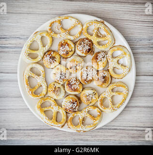 Tasty sesame pastries on the round plate. Food theme. Sesame snacks. Refreshments theme. Stock Photo