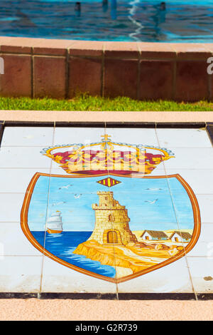 TORREVIEJA, SPAIN - SEPTEMBER 13, 2014: State emblem of city depicted on a white tiled floor, Av de los Marineros, Torrevieja Stock Photo