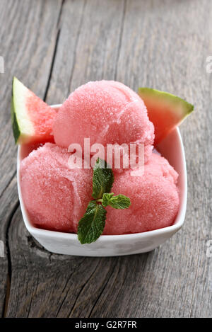 Watermelon ice cream sorbet in bowl on wooden background Stock Photo