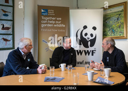 Prime Minister David Cameron (centre) speaks to CEO of RSPB, Mike Clarke (left) and CEO of WWF, David Nussbaun, before being shown around Rainham Marshes RSPB nature reserve by impressionist Alistair McGowan. Stock Photo