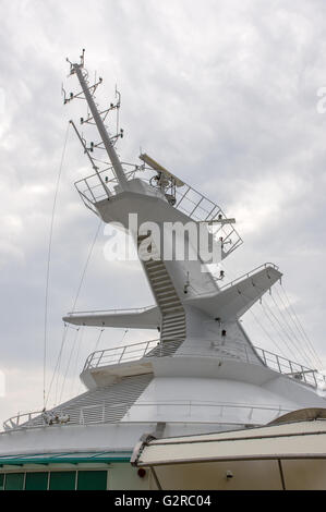 Mast with safety lighting and radar antenna on a cruise ship Stock Photo