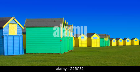 Brightly colored beach huts with blue sky Stock Photo