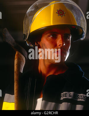 Man in a firefighter outfit, indoors. Stock Photo
