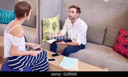 Male and female student studying together at library Stock Photo