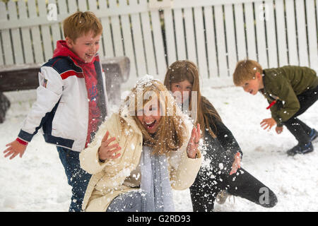 Kate Garraway and (left to right) godson Monty White, daughter Darcey Draper and son Billy Draper play in the snow at London's Cavendish Square to celebrate Disney On Ice presents Frozen coming to the UK. Stock Photo