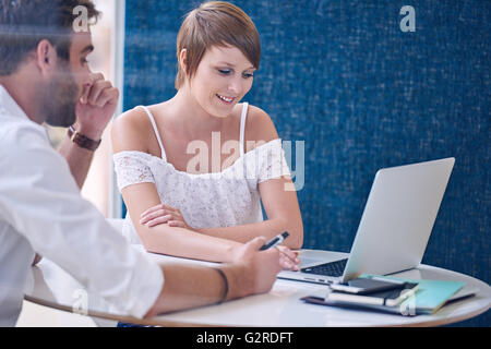 Mentorship between male tutor and female student using modern laptop Stock Photo