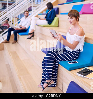 Young pretty caucasian female student working on her tablet Stock Photo