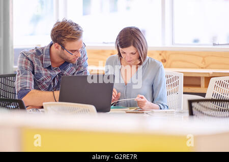 Male and female business professionals working together in office Stock Photo