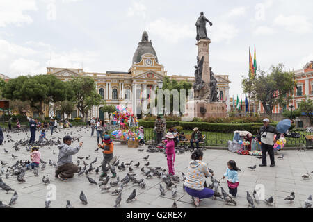 La Paz, Bolivia - October 24, 2015: People feeding pigeon on Plaza Murillo. Stock Photo