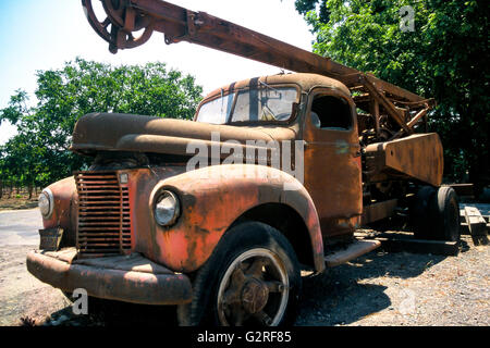 An old farm truck sits abandoned on the side of the road. Stock Photo