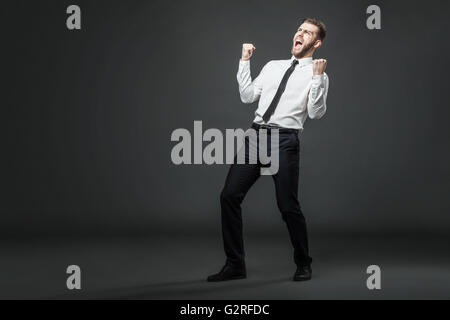 Yeah! The victory is mine! Handsome young businessman celebrating his success. Stock Photo