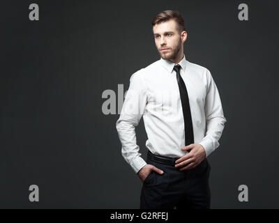 I am cool and successful! Studio portrait of handsome young businessman posing against gray background. Stock Photo