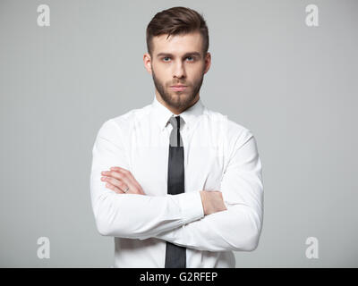 Studio shot of young handsome businessman isolated on gray background. Stock Photo