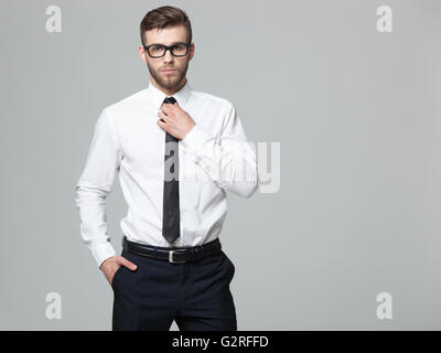 Studio shot of young handsome businessman isolated on gray background. Stock Photo