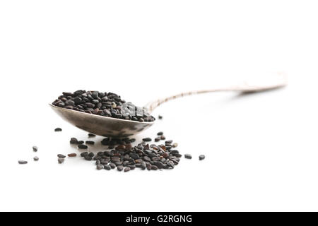 Black sesame seeds. Healthy sesame seeds in spoon  isolated on white background. Stock Photo