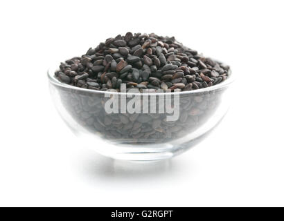 Black sesame seeds. Healthy sesame seeds in bowl  isolated on white background. Stock Photo