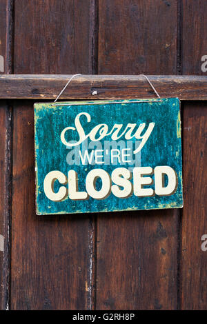 Sorry were closed sign on a shop wooden door. Cotswolds, England Stock Photo