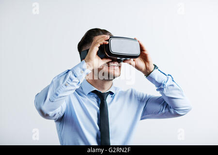Young man in vr headset using future technology Stock Photo