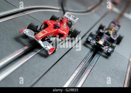 Model formula one style slot cars racing on a track Stock Photo