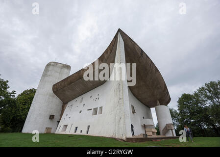 The amazing Chapel of Notre Dame du Haut designed by the famous architect Le Corbusier, Ronchamp, France, and people walking ins
