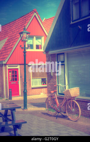 Vintage Dutch town of Volendam European evening. Retro style. houses and bikes on the street in the summer Stock Photo