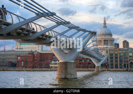 LONDON, UK - JUNE 10, 2015: People crossing the Millennium Bridge linking the City of London with the South Bank between St Paul Stock Photo