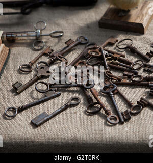 Many old keys on a well used old canvas . Stock Photo