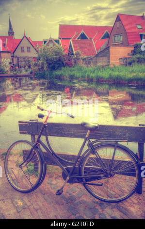 Vintage Dutch town of Volendam European evening. Retro style. houses and bikes on the street in the summer Stock Photo