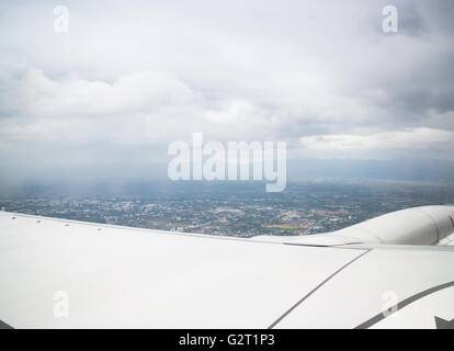 Clouds and land as seen through window of an aircraft, stock photo Stock Photo