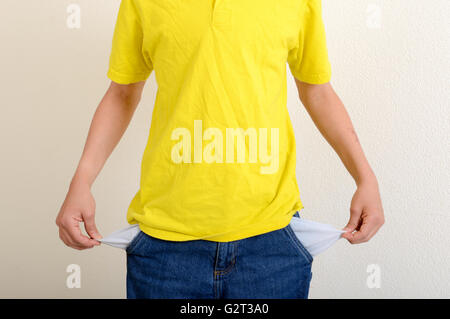 Boy showing empty pockets without money Stock Photo