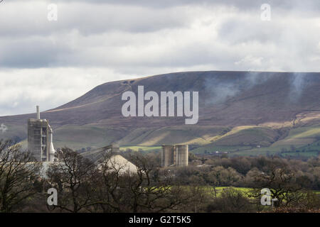 Cement tower in front of Pendle hill Stock Photo