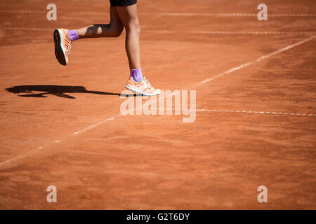 Tennis balls in the shade nets on the ground of clay court Stock Photo