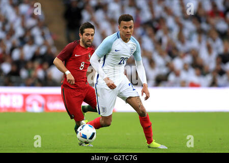 England's Dele Alli in action with Portugal's Joao Moutinho (left) during the International Friendly at Wembley Stadium, London. Stock Photo