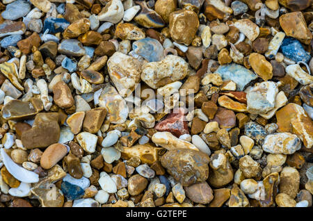 A close-up view of small stones and shingle on the beach. Stock Photo