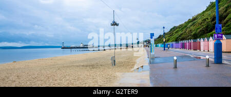 A view along the seafront and Boscombe beach towards Bournemouth pier on a wet and cloudy day.
