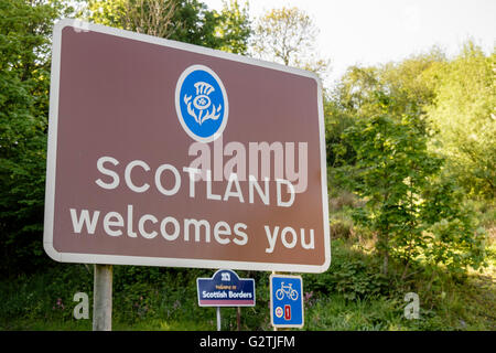 Scotland Welcomes You road sign on English Scottish border with cycle route 1 sign. Berwickshire Scottish Borders Scotland UK Stock Photo