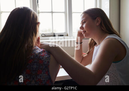 Teenage Girl Comforting Friend Suffering With Depression Stock Photo