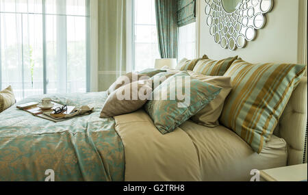 Decorative set with book,tea set and glasses on the bed Stock Photo