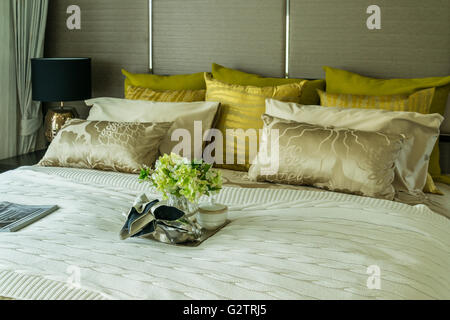 Decorative set with book,tea set and glasses on the bed Stock Photo