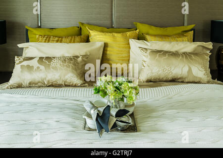 Decorative set with book,tea set and glasses on the bed Stock Photo