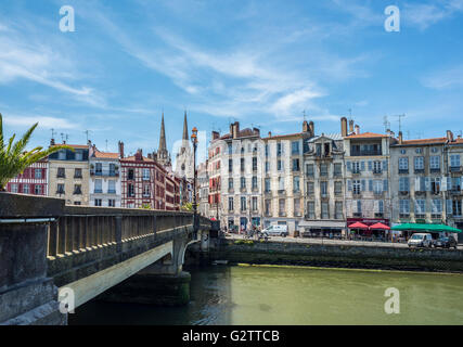 Pont Marengo bridge over Le Nive river with the Cathedral of Sainte-Marie de Bayonne in background. Aquitaine, France. Stock Photo