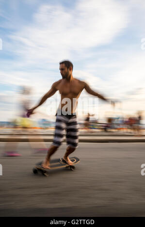 RIO DE JANEIRO - MARCH 6, 2016: Young carioca Brazilian man on skateboard on the beachfront Avenida Vieira Souto in Ipanema. Stock Photo