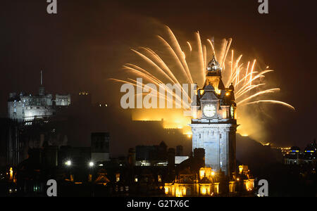 Scotland, Edinburgh, Fireworks for the closing of the Festival & Military Tattoo, view from Calton Hill across to the Castle with the clocktower & Balmoral Hotel. Stock Photo